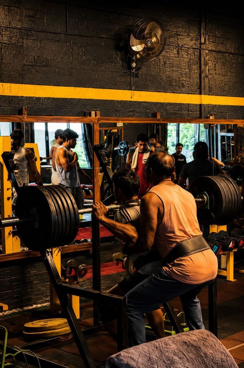 Members training at the squat rack
