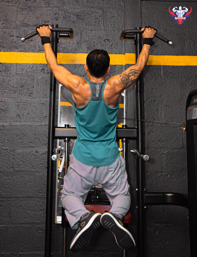 Member pressing dumbbells on an incline bench